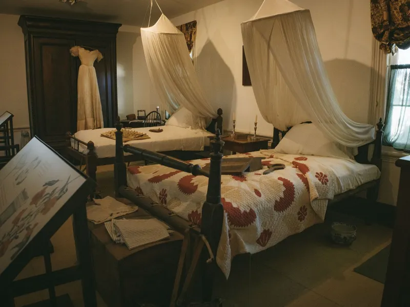 Period bedroom exhibit with canopy bed and antique furniture in a Key West museum