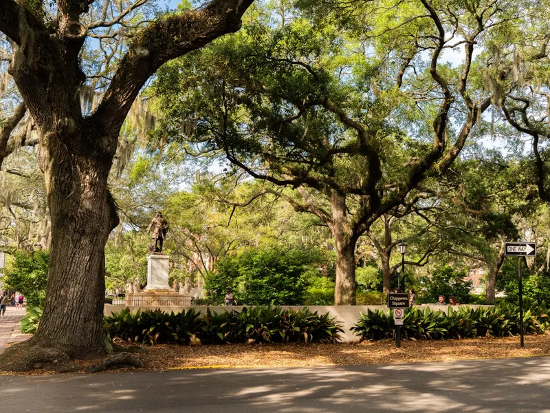 Chippewa Square in Savannah with massive live oaks draped in Spanish moss around a historic monument