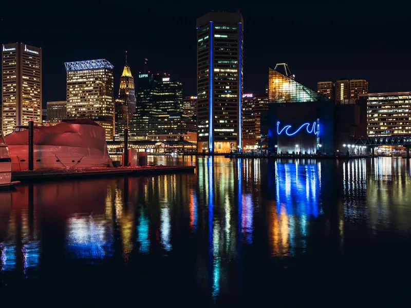 Baltimore skyline reflected in the Inner Harbor at night