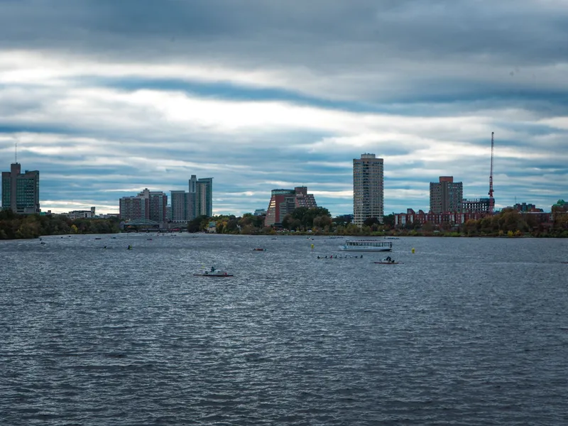 Boston skyline across the Charles River with rowing boats on the water