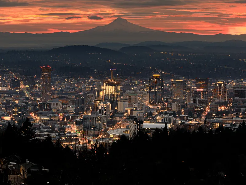 Portland, Oregon lights at sunset with Mount Hood on the horizon