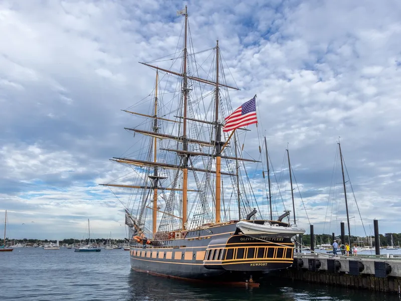 Tall ship flying an American flag at the dock in Newport Harbor, Rhode Island