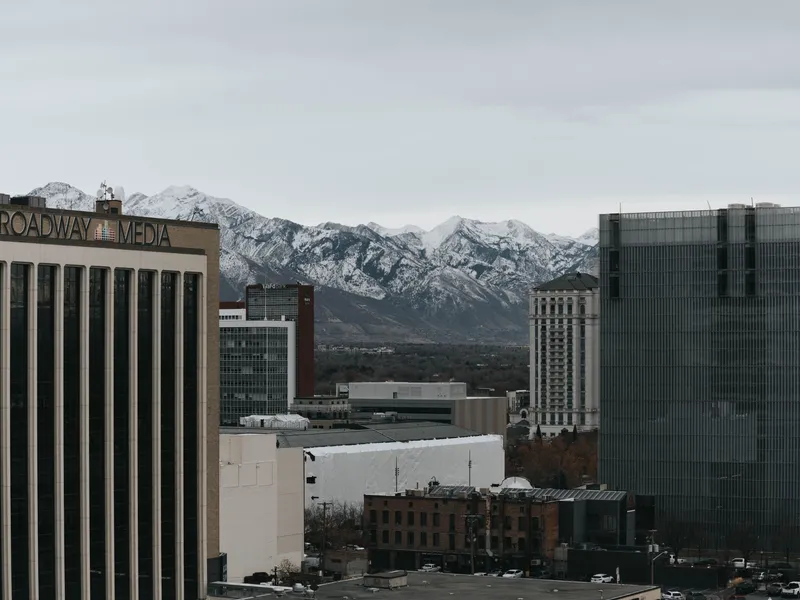 Salt Lake City buildings with the snow-capped Wasatch Range behind them