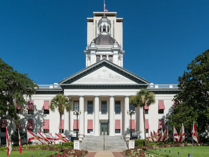 Old Florida State Capitol in Tallahassee, a white columned building with red-striped awnings and a domed cupola