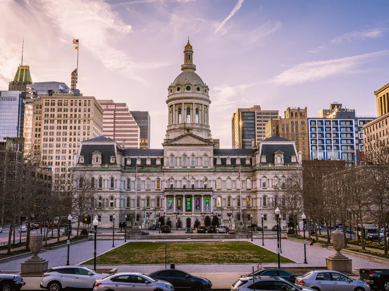 Baltimore City Hall with its dome and the downtown skyline behind it