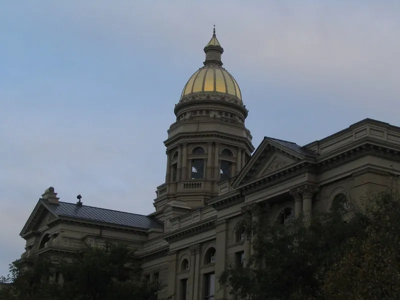 Wyoming State Capitol in Cheyenne with its gold dome rising against a dusk sky