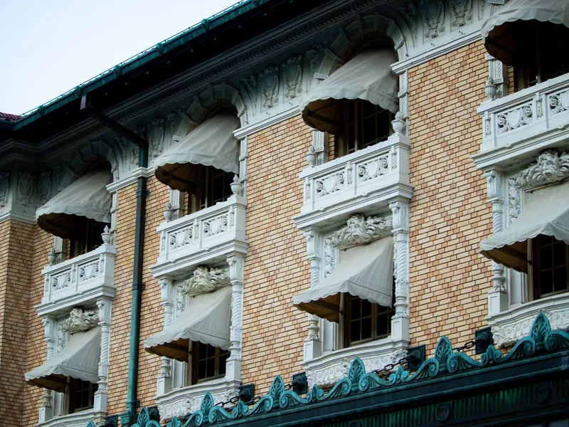 Ornate brick facade with balconies and canvas awnings on historic Bathhouse Row in Hot Springs, Arkansas