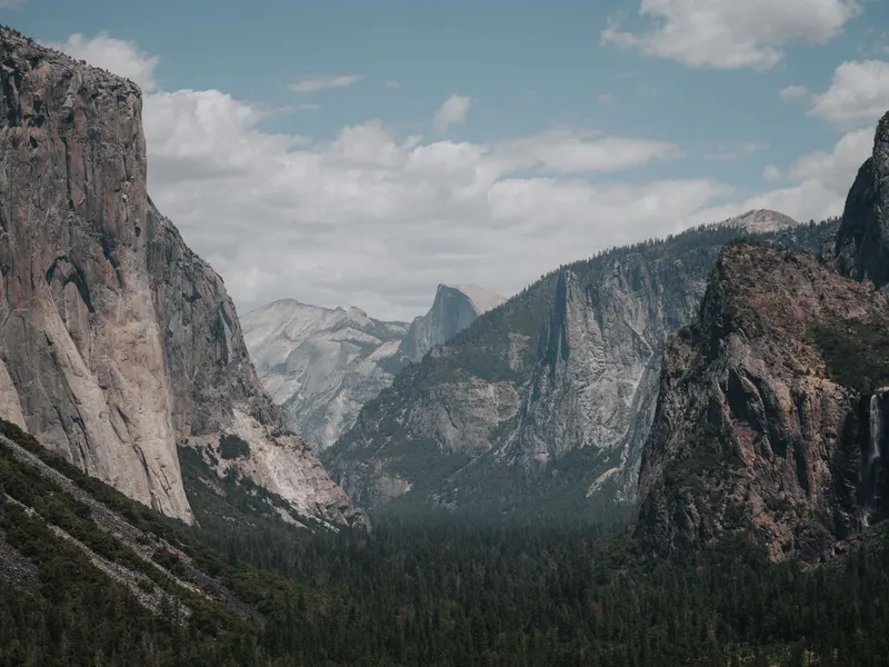 Yosemite Valley with El Capitan granite cliff, forested valley floor and Half Dome in the distance