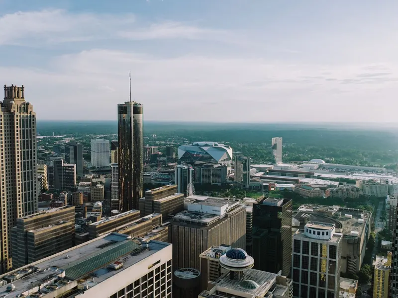 Aerial view of the Atlanta skyline with high-rise towers and a stadium in the distance