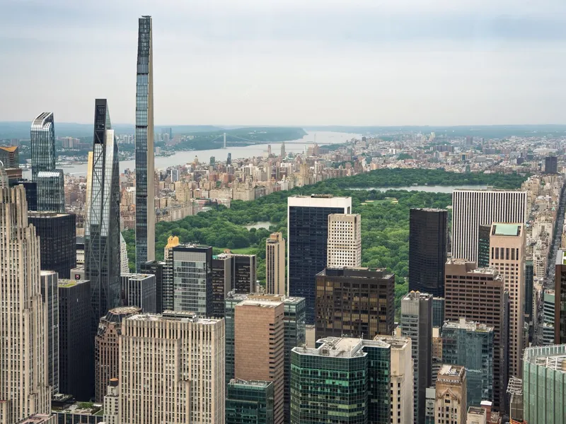 Aerial view of Midtown Manhattan skyscrapers with Central Park and the Hudson River stretching beyond